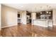 Spacious kitchen featuring an island, stainless steel appliances, and dark wood cabinets, seamlessly flowing into the dining area at 19722 W 59Th Ave, Golden, CO 80403