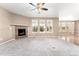 Spacious living room featuring plush carpet, a decorative fireplace, and an abundance of natural light at 19722 W 59Th Ave, Golden, CO 80403