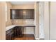 Cozy office space with dark wood cabinets, granite countertops, and hardwood floors, perfect for remote work at 19722 W 59Th Ave, Golden, CO 80403