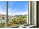 Window view of backyard, neighboring houses, and mountains on a beautiful sunny day at 19722 W 59Th Ave, Golden, CO 80403