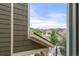 Window view of neighboring houses, lush greenery, and mountains in the distance at 19722 W 59Th Ave, Golden, CO 80403