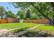 Large backyard featuring lush lawn, tall fencing, and privacy at 740 Cherry St, Denver, CO 80220