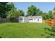 Backyard featuring green lawn and a detached garage at 740 Cherry St, Denver, CO 80220