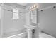 Bathroom featuring pedestal sink, medicine cabinet, and subway tile at 740 Cherry St, Denver, CO 80220