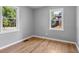 Sunlit bedroom with hardwood floors and large windows at 740 Cherry St, Denver, CO 80220