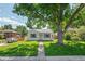 Well-maintained single-story home with a large tree in the front yard at 740 Cherry St, Denver, CO 80220