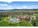 Breathtaking aerial view of a community with pool, clubhouse, and tennis courts against a mountain landscape at 10743 W Turtle Mtn, Littleton, CO 80127