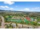 Stunning aerial view of community amenities with tennis courts, pool, and mountains in the background at 10743 W Turtle Mtn, Littleton, CO 80127