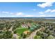 Expansive aerial view showcasing community amenities, including a baseball field and tennis courts at 10743 W Turtle Mtn, Littleton, CO 80127