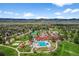 Gorgeous aerial view of a community clubhouse, pool, playground, and tennis courts with mountain views at 10743 W Turtle Mtn, Littleton, CO 80127