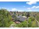 Aerial view of home showing large deck, spacious yard, mature trees, and neighborhood at 10743 W Turtle Mtn, Littleton, CO 80127