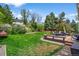 Great backyard featuring a large lawn and a spacious deck with outdoor dining area at 10743 W Turtle Mtn, Littleton, CO 80127