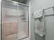 Bathroom featuring glass shower doors and gray towel hanging on a towel rack at 10743 W Turtle Mtn, Littleton, CO 80127