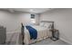 Cozy bedroom with a wrought iron bed frame, soft carpet, and a quaint window letting in natural light at 10743 W Turtle Mtn, Littleton, CO 80127