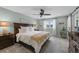 Spacious primary bedroom features an elegant bed, a ceiling fan, and plenty of natural light at 10743 W Turtle Mtn, Littleton, CO 80127