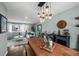 Open-concept space featuring a wooden dining table, stylish lighting, and seamless flow to the cozy living area at 10743 W Turtle Mtn, Littleton, CO 80127