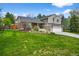 Charming two-story home with a brick accent, lush green lawn, and an attached two-car garage at 10743 W Turtle Mtn, Littleton, CO 80127