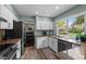 Modern kitchen featuring granite counters, stainless steel appliances, and a view to a lush backyard at 10743 W Turtle Mtn, Littleton, CO 80127