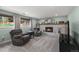 Comfortable living room featuring a brick fireplace, soft lighting, and neutral tones at 10743 W Turtle Mtn, Littleton, CO 80127
