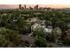 A stunning aerial view of this modern home in a lush neighborhood with the city skyline in the distance at 2523 N Humboldt St, Denver, CO 80205