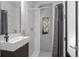 Modern bathroom with a sleek vanity, tiled shower, and a recessed storage niche at 2523 N Humboldt St, Denver, CO 80205