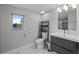 Bright bathroom with modern fixtures, including a dark vanity and sleek mirror at 2523 N Humboldt St, Denver, CO 80205