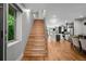 Bright entryway featuring a staircase, hardwood floors, and an open layout with sight lines to the kitchen at 2523 N Humboldt St, Denver, CO 80205