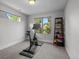 A home gym with stationary bike, natural light, and a storage rack at 2523 N Humboldt St, Denver, CO 80205