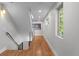 Bright hallway with hardwood floors, modern railing, and a window that brings in natural light at 2523 N Humboldt St, Denver, CO 80205