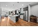 Modern kitchen with stainless steel appliances, a large island, and hardwood floors at 2523 N Humboldt St, Denver, CO 80205