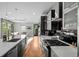 Contemporary kitchen with stainless steel appliances, a large island, and hardwood floors at 2523 N Humboldt St, Denver, CO 80205