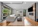 Open living room with a large sectional sofa, fireplace, and a glass garage door at 2523 N Humboldt St, Denver, CO 80205