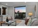 Cozy living area opens to a balcony with stunning city views at sunset at 2523 N Humboldt St, Denver, CO 80205