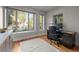 Bright office space with large windows, a modern desk, and hardwood floors at 2523 N Humboldt St, Denver, CO 80205