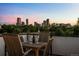 Enjoy the beautiful city views from this rooftop deck furnished with a wooden table and chairs at 2523 N Humboldt St, Denver, CO 80205