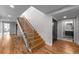 Modern staircase featuring hardwood steps, metal railings and access to other rooms at 2523 N Humboldt St, Denver, CO 80205
