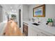 Modern wet bar with sleek countertops and stainless steel accents, plus mini-fridge at 2523 N Humboldt St, Denver, CO 80205