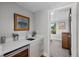 Convenient wet bar features a sink, mini-fridge, and access to an adjacent room at 2523 N Humboldt St, Denver, CO 80205