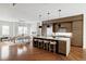 Open kitchen with modern appliances, a center island with seating, and hardwood floors at 2742 Hazel Ct, Denver, CO 80211