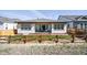 Exterior shot of a fenced backyard with a patio and well-kept lawn at 17240 Hop Clover Ave, Parker, CO 80134