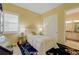 Cozy bedroom features bright yellow walls, a sliding closet door, and an en-suite bathroom at 17240 Hop Clover Ave, Parker, CO 80134