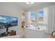 Bright home office features a custom desk, large windows with views, and stylish contemporary lighting at 17240 Hop Clover Ave, Parker, CO 80134
