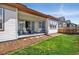 Charming covered patio with outdoor seating, a fire pit, and access to a well-maintained lawn at 17240 Hop Clover Ave, Parker, CO 80134