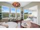 Bright sitting area with ample natural light, large windows with views, and hardwood floors at 17240 Hop Clover Ave, Parker, CO 80134