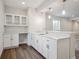 New bar area featuring white cabinetry, quartz counters, stainless faucet, pendant lighting and hardwood floors at 4735 Twelve Oaks Way, Castle Rock, CO 80104