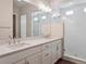 Bathroom featuring double vanity sinks, bright lighting, and a glass-enclosed shower at 4735 Twelve Oaks Way, Castle Rock, CO 80104