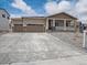 Charming single-Gathering home with a covered front porch, stone accents and a three-car garage at 4735 Twelve Oaks Way, Castle Rock, CO 80104