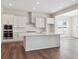 Stylish kitchen with white cabinetry, stainless steel appliances, quartz countertops, and an island at 4735 Twelve Oaks Way, Castle Rock, CO 80104