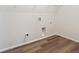 Practical laundry room with wood-look flooring and conveniently placed washer and dryer hookups at 4735 Twelve Oaks Way, Castle Rock, CO 80104