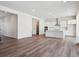 Spacious living area adjoining a modern kitchen, offering a seamless flow for living and entertaining at 4735 Twelve Oaks Way, Castle Rock, CO 80104
